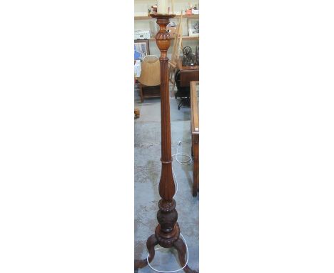 Mahogany column standard lamp on three ornately carved outsplayed supports and carved paw feet and beige lampshade H169cm (on