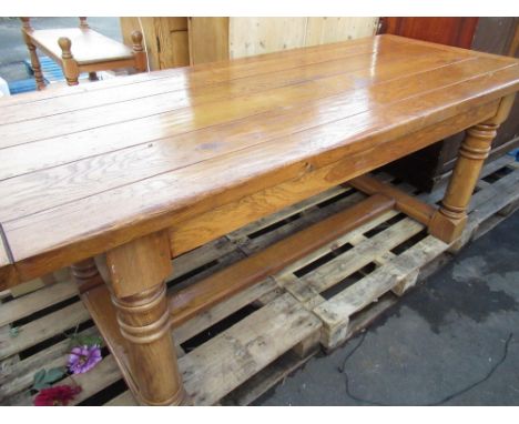 Craftsman made oak refectory style dining table with planked top on gun barrel turned and block supports, joined by floor str