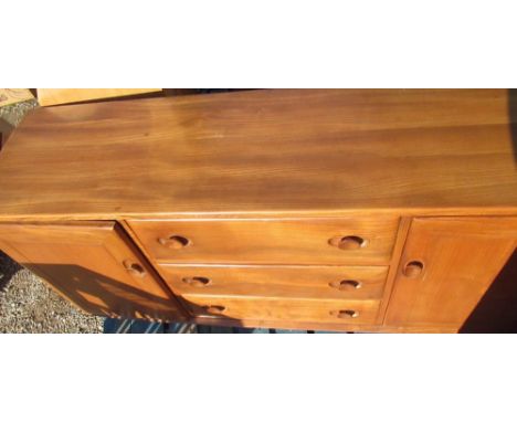 Ercol light elm rectangular sideboard with two cupboards enclosing three drawers W115cm D43cm H68cm 