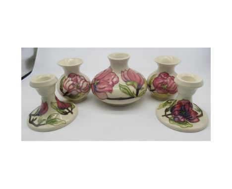 Collection of Moorcroft including two small baluster vases, a larger squat vase and two candlestick holders all decorated wit