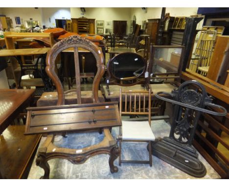 A walnut salon chair frame, on white china castors, a mahogany billiard scorer, a cast iron umbrella stand, two dressing mirr