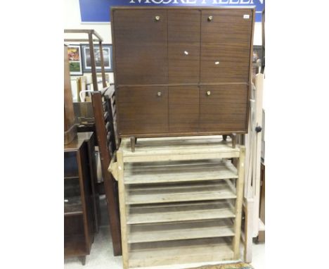 A stained beech baker's slatted six tier shelf rack, a 1960's six door cabinet, a stained beech artist's easel, formica venee