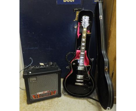 A Les Paul Copy Agile 3100 black six string electric guitar No'd. A09040, in hard case, together with a Roland Cube 40 Excel 