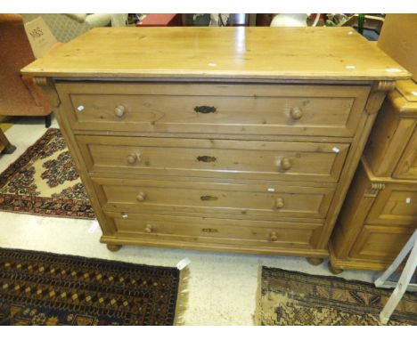A Continental pine commode of four long drawers on turned feet