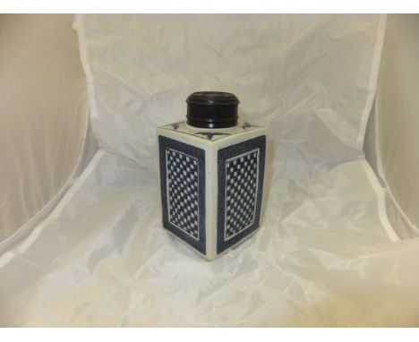 A Chinese blue and white tea caddy of square form, each side decorated with a blue and white chequerboard pattern surrounded 