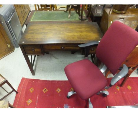 A modern computer desk with brass pull ring handles, a modern office swivel chair, an oak two-tier side table, and JOY ML FER