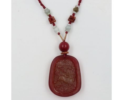 20th century carved red jade pendant, on a strung necklace further beaded with jade. UK P&amp;P Group 1 (£16+VAT for the firs