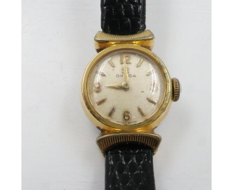 OMEGA: ladies manual wind wristwatch, gold plated case and on a black leather Omega strap, working at lotting. UK P&amp;P Gro