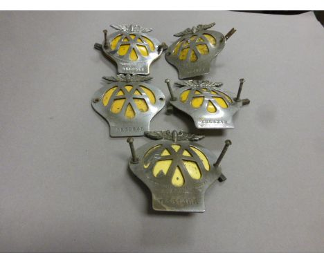 A group of five vintage AA (Automobile Association) car badges