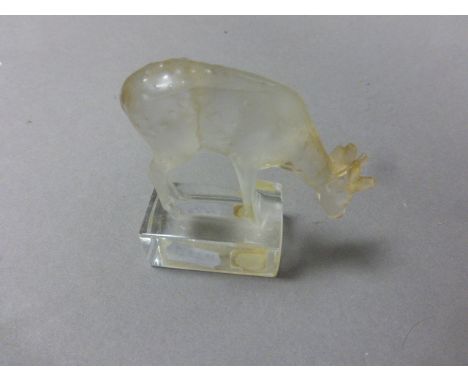 A small Lalique model of a standing deer; raised on rectangular plinth, bearing etched signature and original paper label