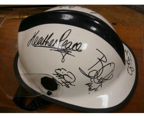 A firefighters helmet as signed by the crew of the TV series London's Burning
