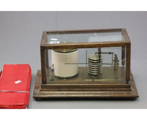 A vintage Watson of London oak and glass cased barograph; together with barograph sheets 