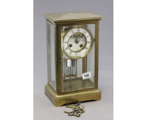 A late 19th century four glass brass mantle clock; with white enamel dial; black painted Roman numerals; with keys and pendul