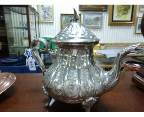 An Arabic silver teapot; bearing impressed marks to base; with bird finial; raised on four curved supports