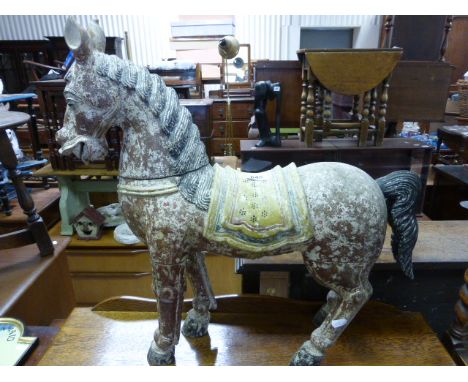 A painted wooden model of a horse