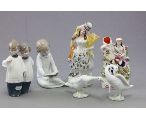 Two Nao porcelain figures; Two choir boys and a girl reading; together with Lladro porcelain geese and two Staffordshire flat