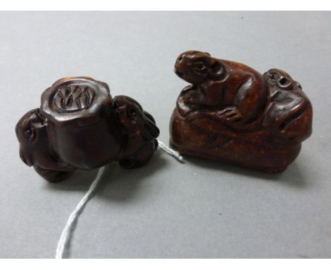 Two wood netsuke carvings to include mice on shoe and three rabbots