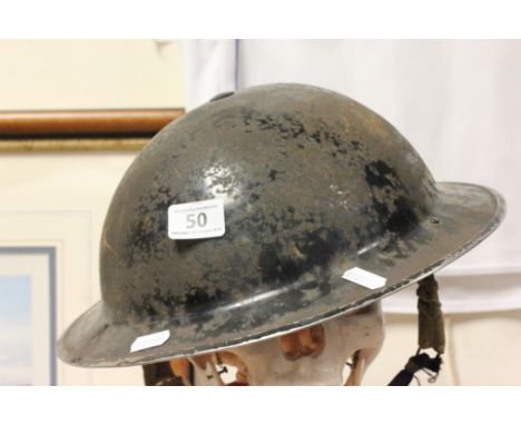 A World War II military tin helmet