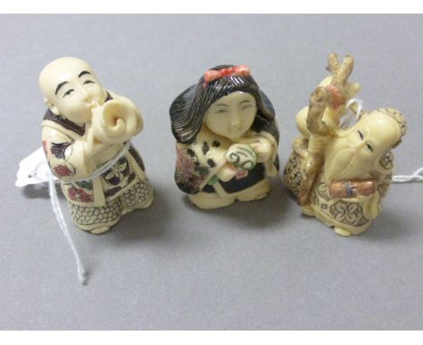 Three netsuke type carvings to include Boy Buddha playing horn, old man traveller and lady with offering