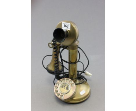 A vintage brass stick telephone