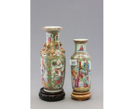 A Chinese canton enamel famille rose porcelain vase; decorated with interior scenes; raised on a fitted pierced hardwood stan