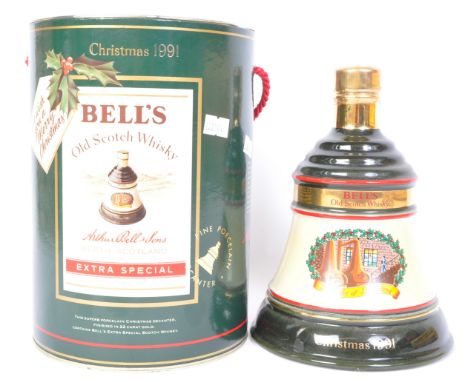 A bottle of Bells Extra Special Old Scotch Whisky Christmas 1991 commemorative example in presentation tin.