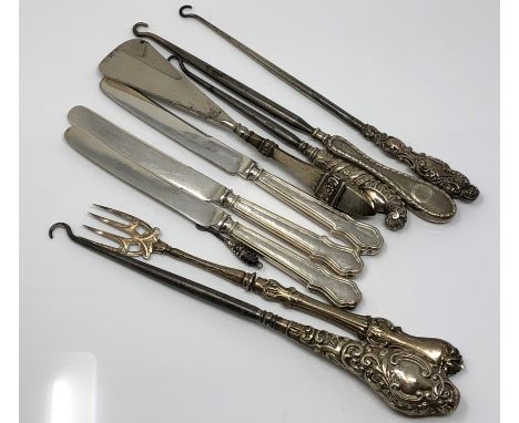 A group of silver mounted button hooks, silver handled knives, shoe horn etc