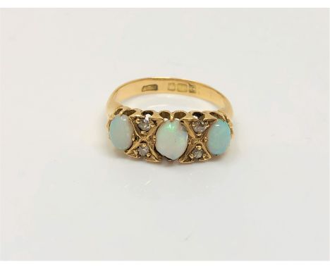 An antique 18ct gold opal and diamond ring, size K CONDITION REPORT: One opal chipped. 