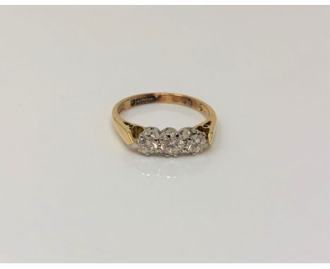 An 18ct gold three stone diamond ring, size K CONDITION REPORT: 2.6g