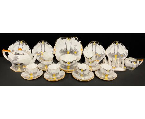 An Art Deco Shelley Sunrise and Tall Trees pattern tea service, comprising tea pot and stand, sugar bowl, milk jug, toast rac