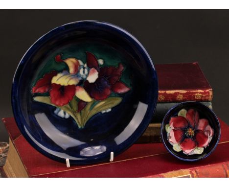 A Moorcroft Iris pattern plate,18cm diameter; a Moorcroft Anemone pattern trinket dish, 7.5cm diameter (2)