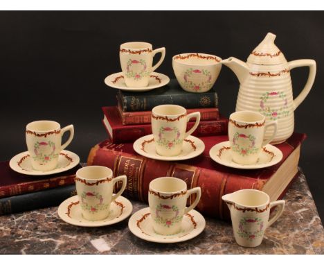 A Clarice Cliff coffee set, painted with floral garlands on a honey glaze ground, comprising ribbed coffee pot and domed cove