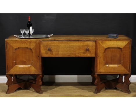 An Arts &amp; Crafts oak sideboard, by Arthur Romney Green (1872-1945), flush rectangular top above a central frieze drawer f