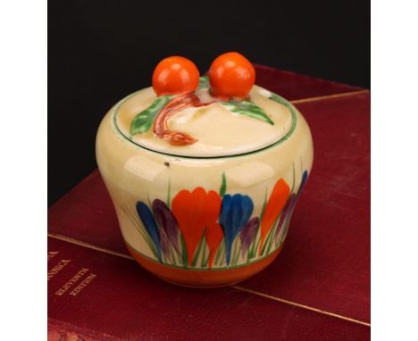A Clarice Cliff Crocus pattern waisted preserve pot and cover, painted in colours with crocuses, banded in tan, orange finial