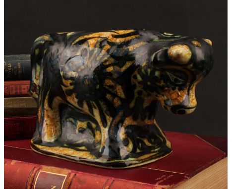Studio Pottery - Maggi Fisher for Celtic Pottery, a stylised model of a bull, hand painted, 13.5cm high, paper label