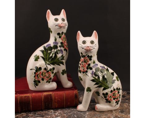 A pair of Griselda Hill Pottery ceramic cat models, painted with brightly coloured thistle and clover, glass eyes, 34cm, pain