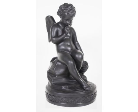 Black basalt seated cupid figure seated ceramic figure, on decorated base. (Height 21cm approx).