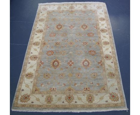 Indian hand made wool rug with light turquoise and tan tones, 187cm x 125cm approx. HALI Handmade Rugs label to back $1720