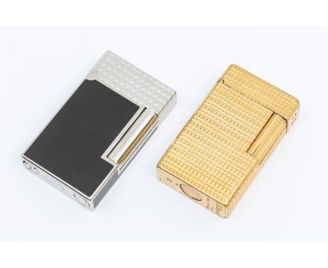 Two Dupont lighters, including a gilt metal lighter and a white metal and black lacquer cased version  (1 bag)  Please note t