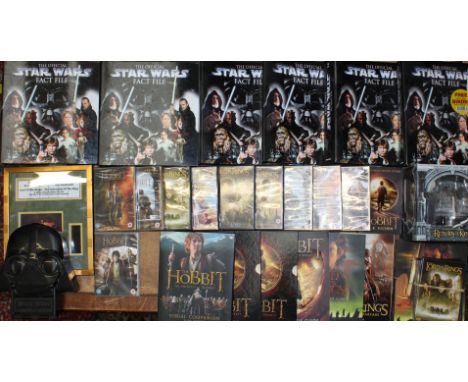 A collection of assorted movie and other collectables to include: Star Wars Fact Files, Lord of the Rings and the Hobbit inte