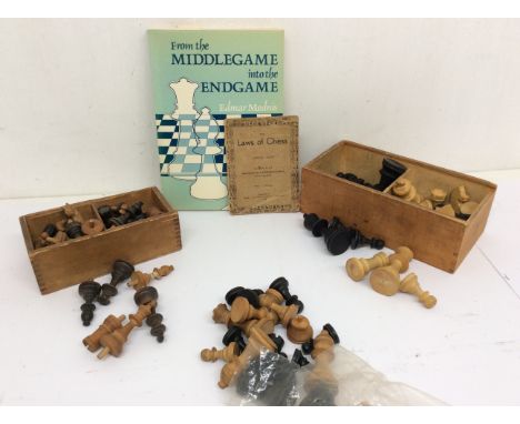 A collection of vintage wooden chess pieces in boxes and loose.