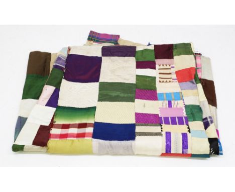  An unfinished silk patchwork quilt in silk fabric in a variety of colours and patterns - striped, floral, checked and plain 