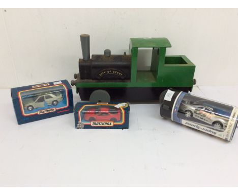 1970s wooden train with City of Derby engine plaque, two boxed Matchbox cars, and a Super Speed boxed car.