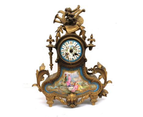 A 19th Century gilt spelter French mantle clock with musical and floral detail, 8 day porcelain face with gilt Roam numerals,