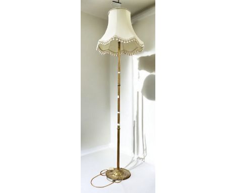 A mid 20th Century brass floor standing standard lamp.
