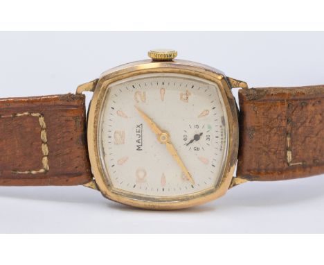 A gents vintage 9ct gold Majex wrist3atch, comprising a silvered cushion shaped dial with applied arrow and Arabic number mar