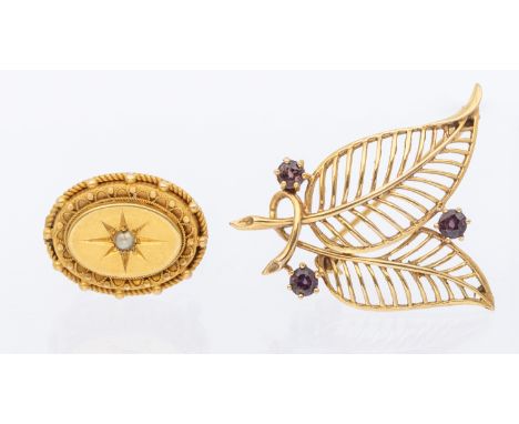 A ruby and 9ct gold brooch in the form of a leaf, set with thee round mixed cut rubies, length approx 30mm, pin and roller cl