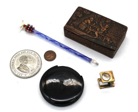 A 19th century walnut snuff box with carved lid; small magnifying glass lacquered pill box, with commemorative coin; Murano g
