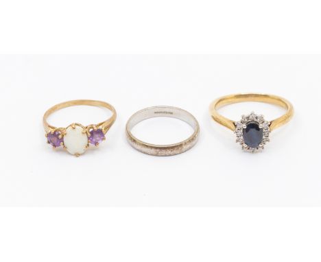 Three 9ct gold rings, including a claw set oval sapphire cluster ring with diamond set surround, width approx 9mm, size P, al