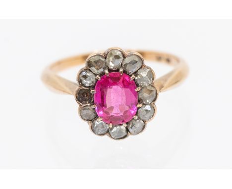 ***TEST STONE CHECK IF SYNETHETIC*** A synthetic ruby and diamond 14ct rose gold cluster ring, set with an oval central stone